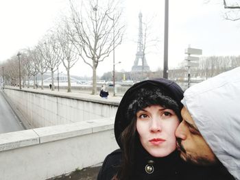 Portrait of young woman standing in snow