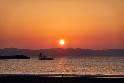 Scenic view of sea against orange sky