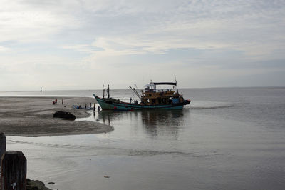 Ship moored on sea against sky