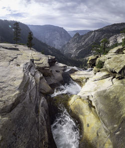 Scenic view of rocks in mountains against sky