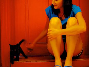 Full length of woman with cat