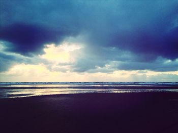 Scenic view of sea against cloudy sky