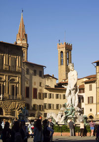 People by neptune fountain in piazza della signoria