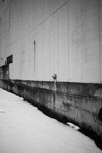 Street by wall against building in winter