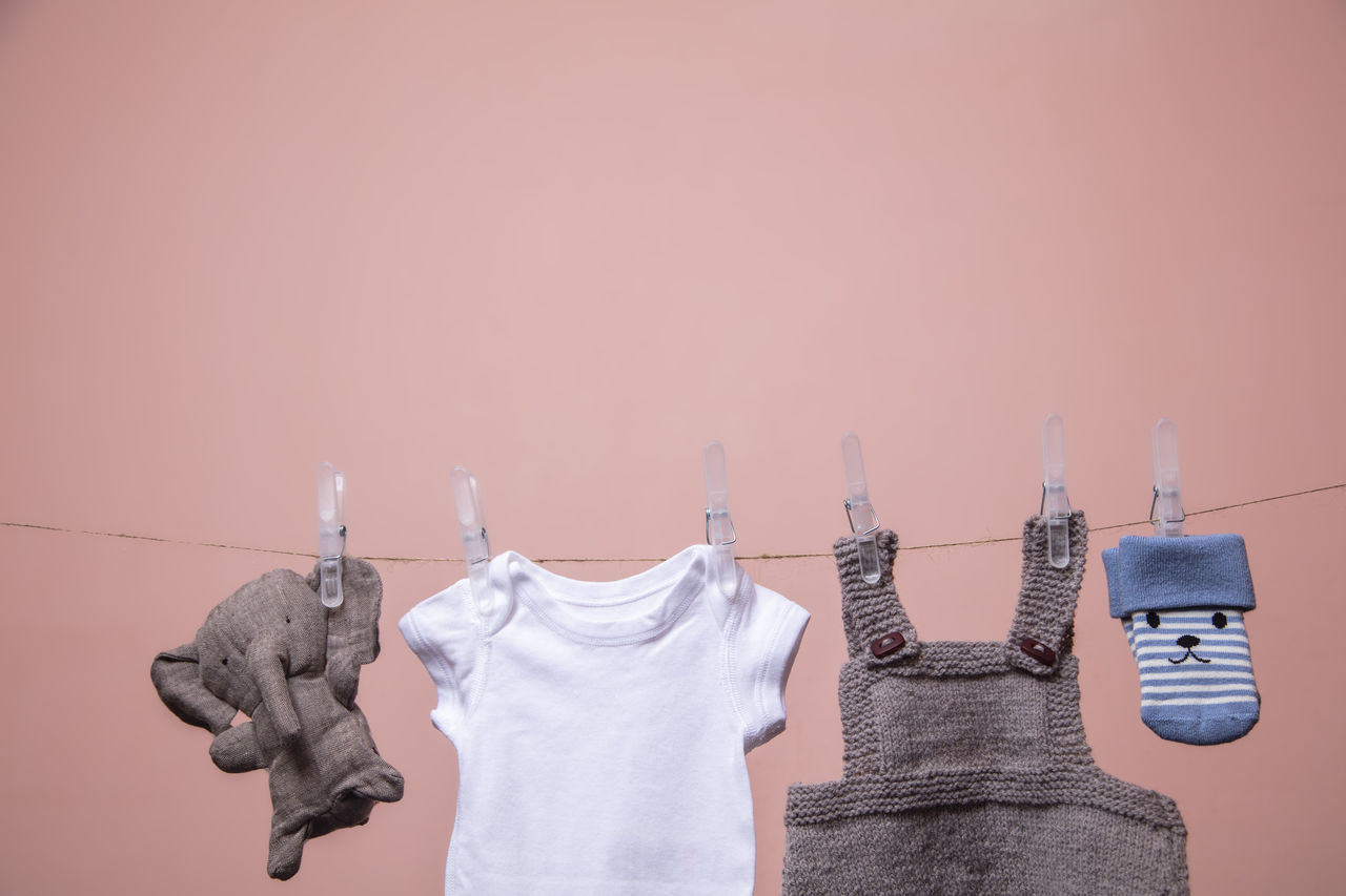 LOW ANGLE VIEW OF CLOTHES HANGING ON WALL