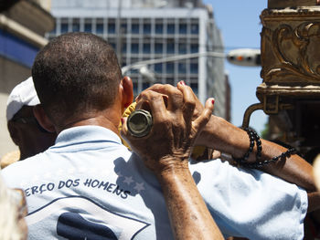 Rear view of man holding ice cream