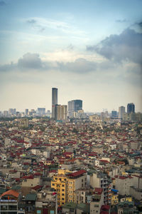 High angle view of buildings in city against sky