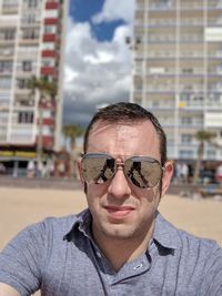 Portrait of man wearing sunglasses at beach