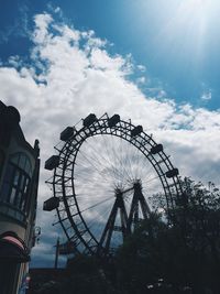 Low angle view of ferris wheel against sky