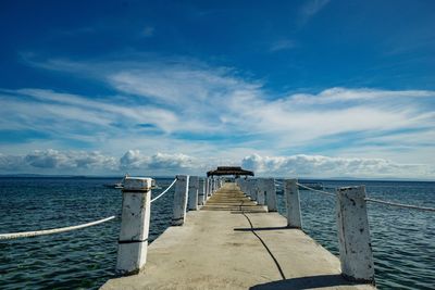 Pier over sea against sky