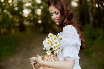 Young woman picking flowers