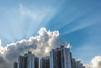 Urban building against crepuscular light of blue sky