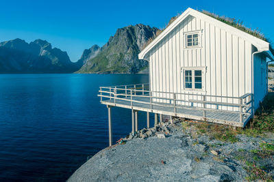 White, wooden fisherman's house with grass on the roof in reine, lofoten, norway. 