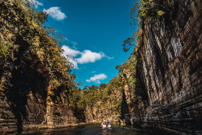 Scenic view of rock formation amidst trees against sky