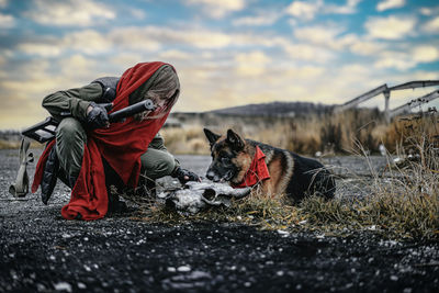 Dog on field against sky during winter