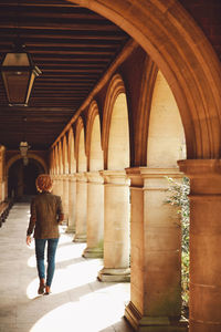 Rear view of woman walking in corridor