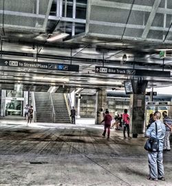 People walking on railroad station platform