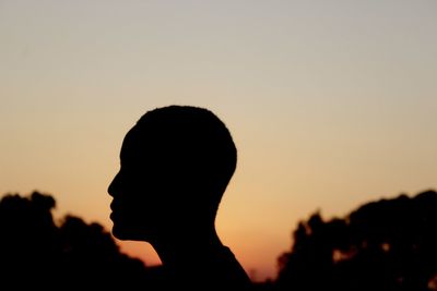 Silhouette man against sky during sunset