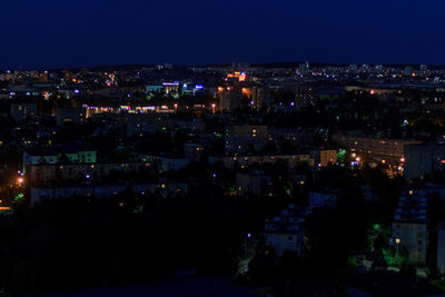 High angle view of city lit up at night