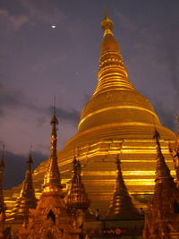 Illuminated temple against sky at night