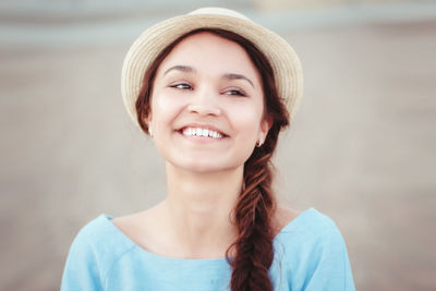 Close-up of woman wearing hat at beach