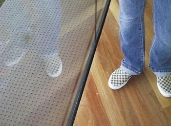 Low section of woman standing on tiled floor