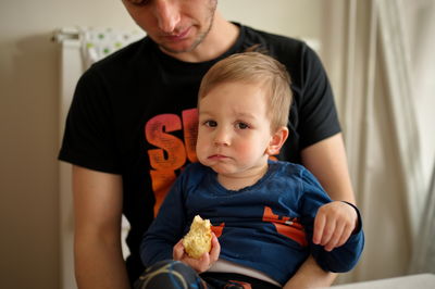 Portrait of boy with dog at home