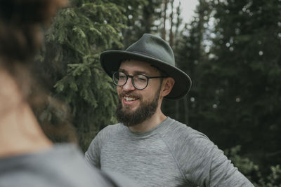 Smiling bearded man wearing eyeglasses and hat