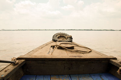 Meking river, vietnam. wooden boat. tyre in front to avoid damage.