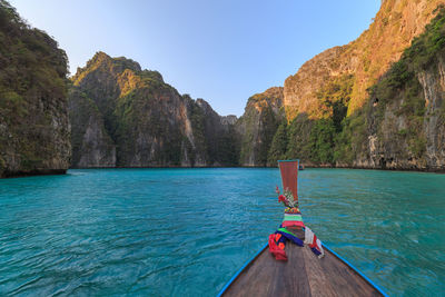 Scenic view of mountain by sea against clear sky