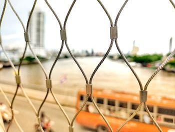 Close-up view of the bridge over the chao phraya river through the iron fence. 