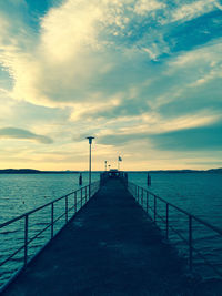 Pier over sea against sky