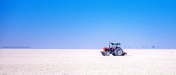 Tractor on landscape against sky