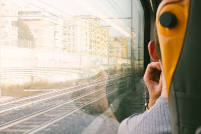 Rear view of man on train