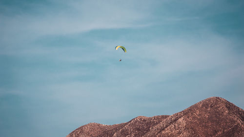 Low angle view of paragliding against sky