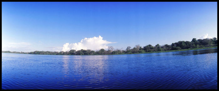 Panoramic view of lake against blue sky