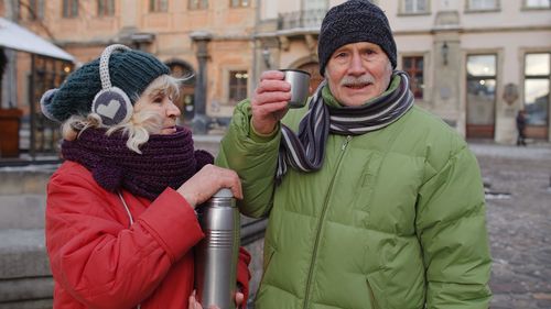 Senior couple standing outdoors during winter