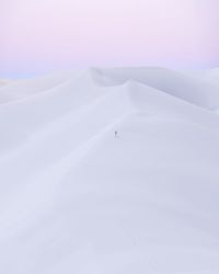 Scenic view of white sands against sky