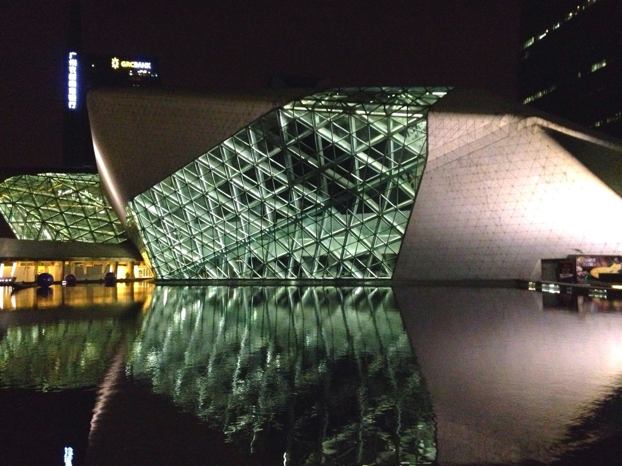 indoors, reflection, illuminated, architecture, built structure, water, night, no people, table, building exterior, waterfront, house, decoration, lighting equipment, modern, window, close-up, glass - material, pattern