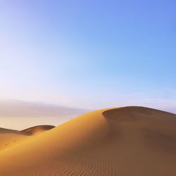 Scenic view of desert against clear sky