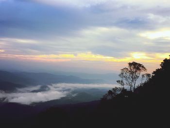 Scenic view of silhouette mountains against sky at sunset