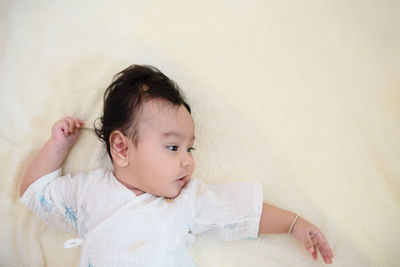 Portrait of cute boy lying on floor