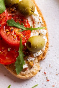 Bruschettas with olives and fresh tomatoes and wineglass