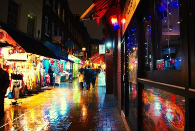 People walking in market at night