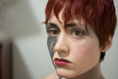 Close-up portrait of woman with face paint