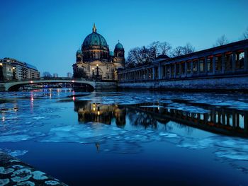 Reflection of bridge and buildings in water