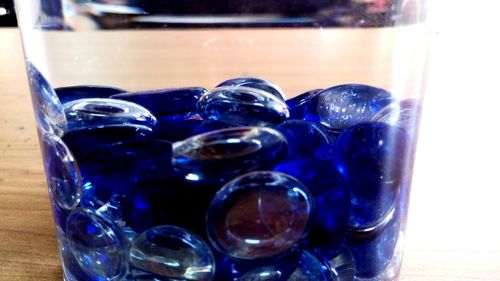 Close-up of blue glasses on table