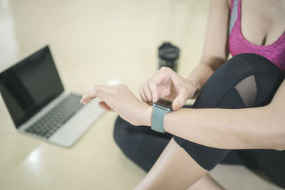 Midsection of woman using mobile phone