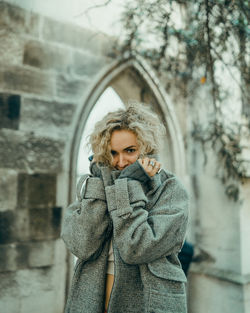 Portrait of woman standing in snow