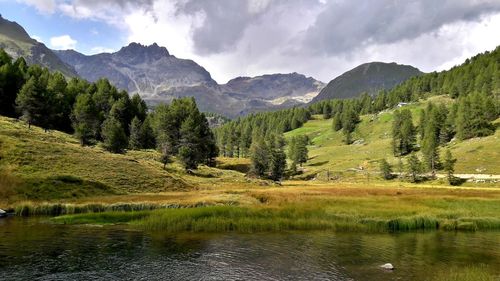 Scenic view of lake and mountains against sky